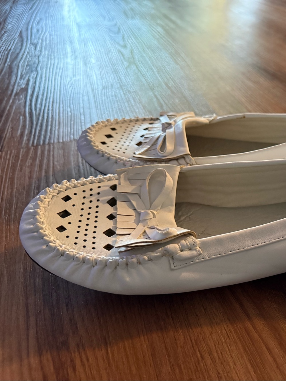 Soft moccasin type shoes in white. Never worn.